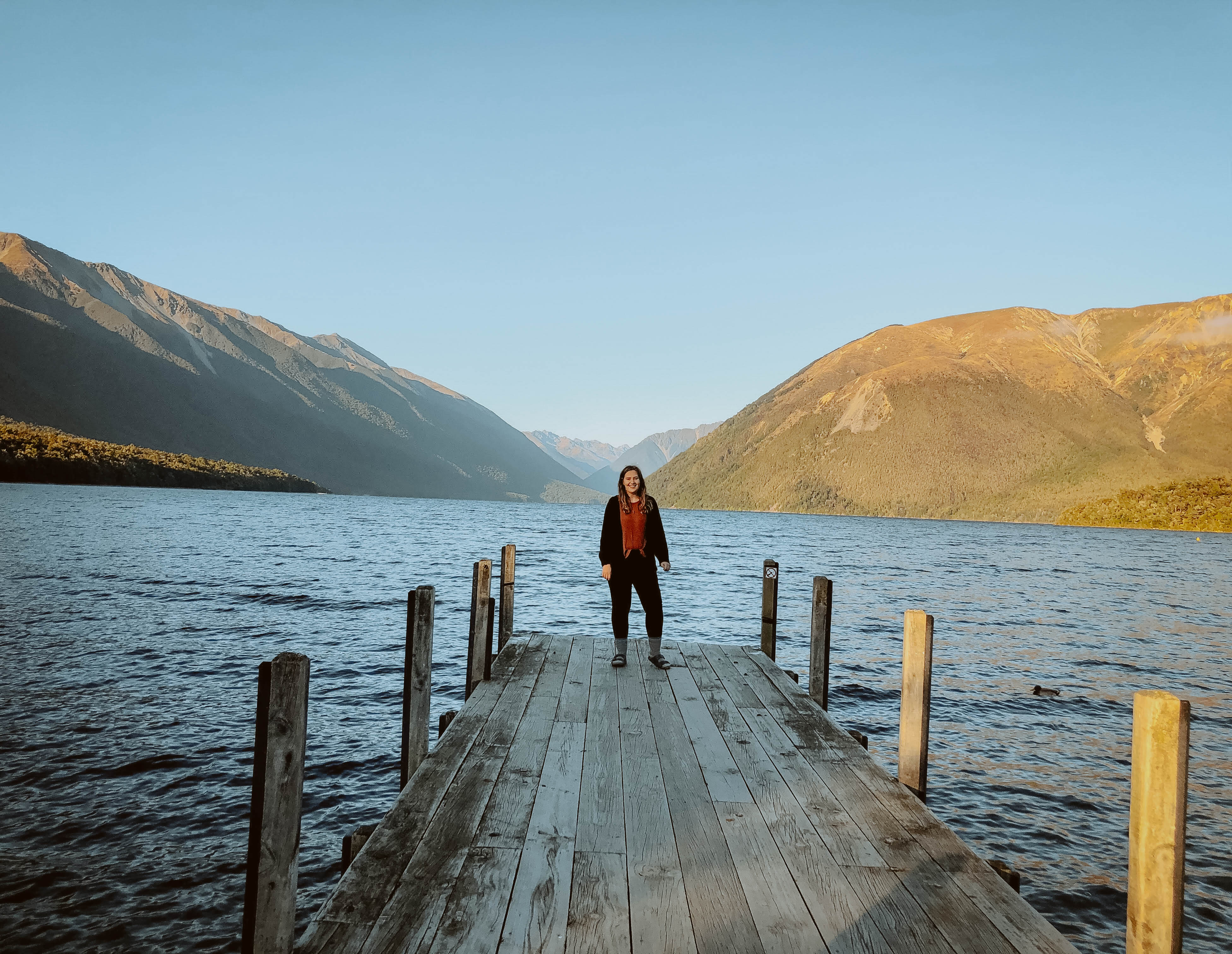 Girl standing in front of mountains Lake Rotoiti New Zealand